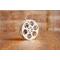 front view of a silver miniature movie reel magnet sitting on a wooden table