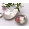 Set of three nesting trinket dishes made from a vintage silverplated brass serving tray. Largest dish is a bird shape, two smaller dishes are round. Photo shows all three side by side, one with tiny rose blossom floating in water.
