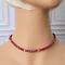 Deep red faceted glass beaded choker necklace on mannequin.