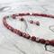 Red faceted glass beads, half coated in silver tone.