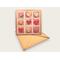 A greeting card made with kraft paper that has 9 hearts in a tic tac toe outline