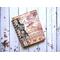 A blank notebook with a vintage ephemera cover and coffee stained paper