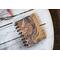 A small blank kraft paper journal or notebook with a vintage ephemera cover