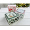 3 white kraft gift boxes that have been decorated with holiday cardstock