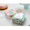 3 handmade white kraft boxes that have been decorated with festive and colorful paper