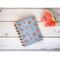 A small blank notebook that has a cover with watermelons on it