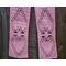 Close-up of a pink scarf showing details of the hearts in the pattern.