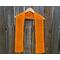 Orange Diagonal Crochet Scarf display on a hanger in front of a wooden fence.