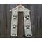 Display of the Ghost Crochet Scarf on a hanger in front of a wooden fence.