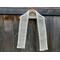 Display of the Diagonal Crochet Scarf Pattern on a hanger in front of a wooden fence.