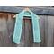 Display of the Diagonal Crochet Scarf on a hanger in front of a wooden fence.