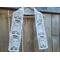 Display of the Ghost Crochet Scarf on a hanger in front of a wooden fence.