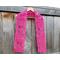 Display of the Tulip Crochet Scarf Pattern on a hanger in front of a wooden fence.