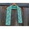 Display of the Vine Crochet Scarf on a hanger in front of a wooden fence.