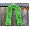 Display of the Easter Crochet Scarf on a hanger in front of a wooden fence.