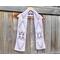 Display of the Hearts Crochet Scarf on a hanger in front of a wooden fence.
