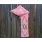 Another pic of a pink scarf with hearts along its length.
