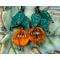 Pumpkin earrings with vintage orange lucite beads glowing in the light