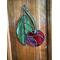 Cherry stained glass ornament on wall.