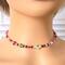 Pink choker necklace on a mannequin.