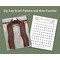 Display of the Zig Zag Crochet Scarf on a hanger in front of a wooden fence and a printable row counter.
