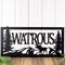 Close up of metal family name plaque with moose and mountains, in matte black powder coat.