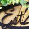 Close up of established year on our custom oval metal sign, in matte black powder coat.