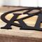 Close up of matte black powder coat on our oval personalized family name sign.