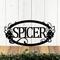 Hanging oval family name metal sign with grapes and grapevines, in matte black powder coat.