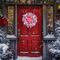 Rustic Christmas door wreath with red and white ribbons on a red door, ideal for farmhouse holiday front door decor.