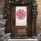 Red and white rustic winter wreath with snowflake accents and candy cane stripes, hanging on a brown farmhouse front door.