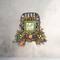 Farmhouse fall tobacco basket wreath with berries, greenery, and a 'Fall Is In The Air' sign. Perfect for rustic autumn wall decor.