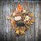 Cozy fall wreath with velvet pumpkins, autumn leaves, and florals for warm harvest decor on your front door.