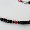 Black glass, spinel and red crystal beads.