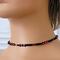 Skinny red heart choker on a mannequin.