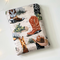 cowboy boots book sleeve has a light rustic brown background, there are cacti and boots, some had cowboy hats on top of them