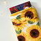 a small book peeking out of the flower book jacket