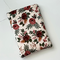 this floral book sleeve has a light brown background with different shades of brown flowers & the leaves are dark green