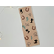 this western bookmark has a brown background with horseshoes, cacti, boots, & rope all over the book mark