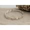 Set of three sterling silver stacking wavy bangle bracelets.
