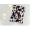 this woodland book sleeve has a light gray background, black trees, plaid and black deer & bears, red & black paw prints