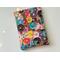 This donut book sleeve has colorful donuts all over the book jacket with different designs on all of the donuts