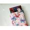 a small book peeking out of the butterfly book holder