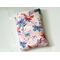 the butterfly book sleeve has a light pink background with white flowers and watercolor butterflies