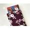 a small book peeking out of the floral book pocket