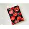 this pumpkin book sleeve has a black background with some pumpkins having sparkly spider web, some are carved and others are not
