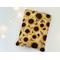 this fall sunflower book sleeve has sunflowers all over the floral book holder with brown leaves