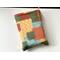 this patchwork book sleeve has fall colors blocks with each color having different prints