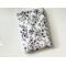 this floral book sleeve has a white background with black floral