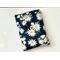 this daisy book sleeve has a navy blue background and the flowers are different size with stems